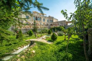 a garden in front of a building at Goreme Inn Hotel Only Adult in Göreme