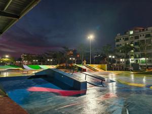 a skate park at night with a skateboard ramp at Santorini Hotel in Miri