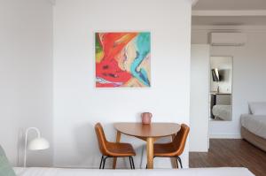 a dining room with a table and two chairs at Harbour View Motel in Robe