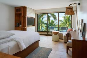 a bedroom with a bed and a desk and a television at Andaz Maui at Wailea Resort - A Concept by Hyatt in Wailea