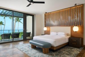 a bedroom with a bed and a view of the ocean at Andaz Maui at Wailea Resort - A Concept by Hyatt in Wailea +155 photos