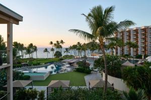 an aerial view of a resort with a pool and palm trees at Andaz Maui at Wailea Resort - A Concept by Hyatt in Wailea