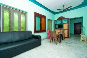 a living room with a couch and a dining room at Karthees Homestay in Rāmeswaram