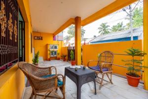 a patio with chairs and a table on a balcony at Karthees Homestay in Rāmeswaram +13 photos