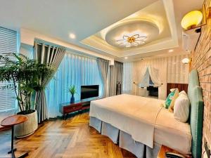 a bedroom with a large bed and a television at Dinh Ami Hanoi Hotel in Hanoi