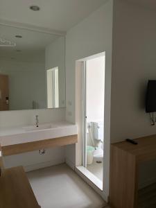 a bathroom with a sink and a mirror and a toilet at Nantra Hua Hin in Hua Hin +63 photos