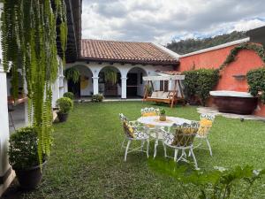 a table and chairs in the yard of a house at Luna Maya Boutique Hotel in Antigua Guatemala