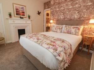 a bedroom with a large bed and a fireplace at South Segganwell - Culzean Castle in Maybole