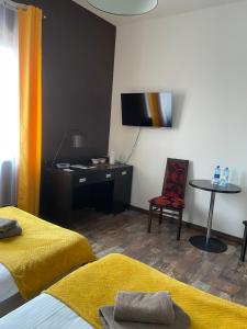 a room with a bed and a desk and a chair at Hotel Altamira in Piotrków Trybunalski