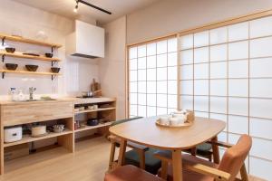 a kitchen with a table and chairs in a room at フォレステージ嵐山 in Kyoto