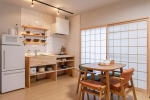 a kitchen with a table and chairs and a refrigerator at フォレステージ嵐山 in Kyoto +51 photos