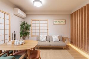 a living room with a couch and a table at フォレステージ嵐山 in Kyoto