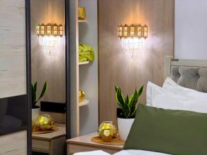 a bedroom with a bed and lights on a wall at Giza Grand Hotel in Tashkent