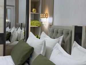 a room with a bunch of pillows on a bed at Giza Grand Hotel in Tashkent +34 photos