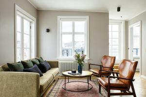 a living room with a couch and two chairs at Kvosin Downtown Hotel in Reykjavík