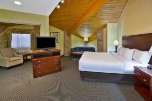 a hotel room with a bed and a television at Quality Inn Marshall near I-69 in Marshall