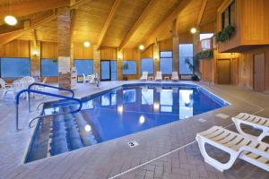 a large swimming pool in a building with chairs at Quality Inn Marshall near I-69 in Marshall