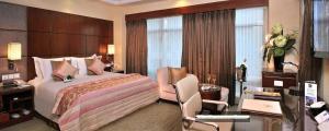 a hotel room with a bed and a desk and a computer at SkyCity Hotel Gurgaon in Gurgaon +139 photos