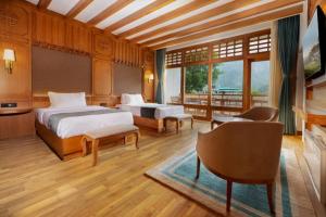 a bedroom with a bed and a couch and a table at Amba Paro in Paro