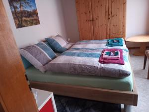 a bedroom with a bed with a quilt on it at Casa Wüstner in Dinkelsbühl