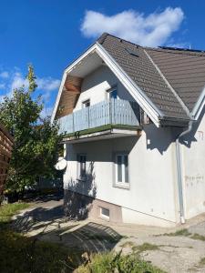 a white house with a balcony on the side of it at Bergluft TOP 1 Modern Apartment with 2 bedrooms 1 hour from Vienna Parking & 24 hour Self Check-in in Grafenbach +6 photos