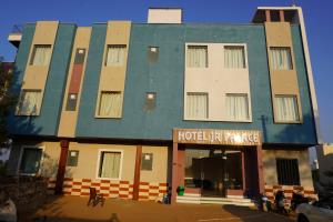 a hotel with a blue and white building at Hotel JR Palace- Near Toran Dwar and free Parking in Khātu