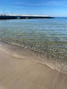 a sandy beach with a pier in the water at Sternik Dom gościnny in Niechorze +40 photos