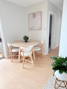 a dining room with a table and chairs at Melrose Place at Flynn's Beach in Port Macquarie