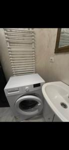 a white bathroom with a toilet and a sink at Studio roberto in Piatra Neamţ