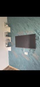 a computer monitor on a wall in a room at Studio roberto in Piatra Neamţ