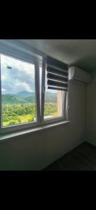 a window in a room with a view of a field at Studio roberto in Piatra Neamţ