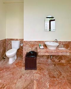 a bathroom with a toilet and a sink at Lorin Resort Belitung in Sijuk +10 photos