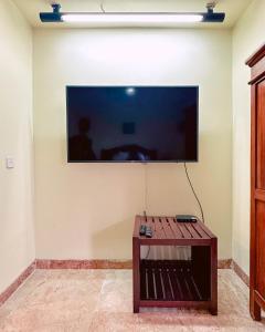 a flat screen tv on a wall in a room at Lorin Resort Belitung in Sijuk