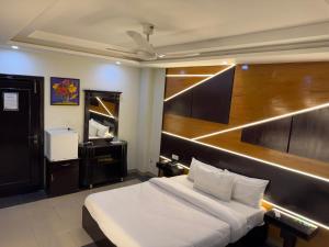 a hotel room with a bed and a piano at Crystal Crown Hotel in Peshawar