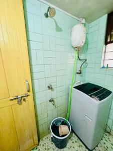 a bathroom with a toilet with a water hose at Flora 2bhk Kothrud MIT WPU in Pune