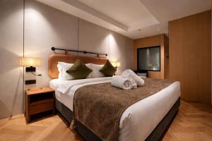 a bedroom with a large bed with two stuffed animals on it at The Green Hall in George Town