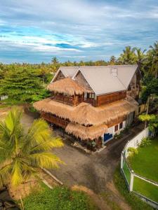 an overhead view of a large building with a straw roof at surf dom hotel & restaurants in Ahangama