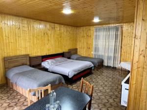 a room with two beds and a table and a table sidx sidx sidx at Apartment BESO in Kutaisi +75 photos