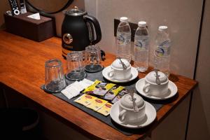 a table with plates and cups and water bottles at The Green Hall in George Town