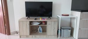 a television on a wooden stand in a living room at Paradise Now in Jomtien Beach