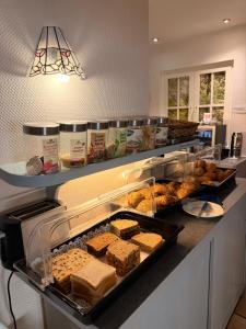 a kitchen counter with many different types of food at Haus am Park in Bad Hersfeld