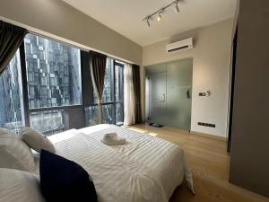a bedroom with a large bed with a large window at Star Residence KLCC By BluekeyKL in Kuala Lumpur +70 photos