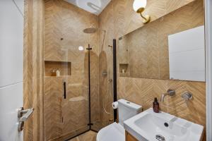 a bathroom with a shower and a toilet and a sink at Coral Alvor Old Town Marina Townhouses Collection in Alvor +85 photos