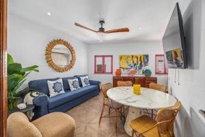 a living room with a blue couch and a table at Coral Alvor Old Town Marina Townhouses Collection in Alvor
