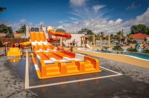 a large playground with a slide at a water park at ZEcamping chiens acceptés animations parc aquatique in Saint-Hilaire-de-Riez
