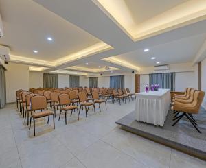 a conference room with a rows of chairs and a table at Hotel The Golden Oaks, Kolhapur in Kolhapur