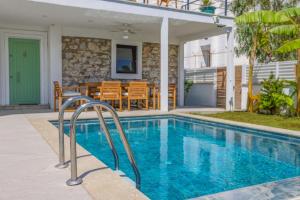 a swimming pool in front of a house at Traditional Seaside Stone Villa with Private Pool in Bodrum City