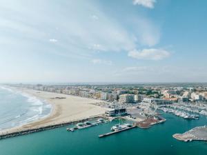an aerial view of a beach with boats in the water at ZEcamping 4 familial piscine chauffée club enfant animations au calme in Canet-en-Roussillon