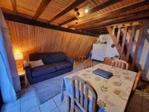 a living room with a table and a couch at Là-Haut in Les Angles