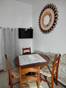 a dining room table with two chairs and a mirror at L'antica Terrazzella in Vasto